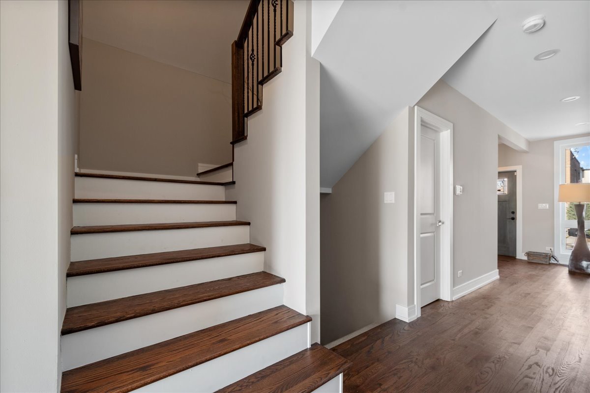 4855 West School Street Chicago, IL 60641 - Photo 16 of 29 a view of entryway with wooden floor and stairs