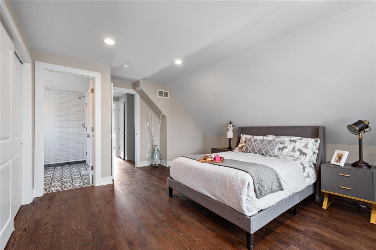 4855 West School Street Chicago, IL 60641 - Photo 18 of 29 a bedroom with a bed and a table