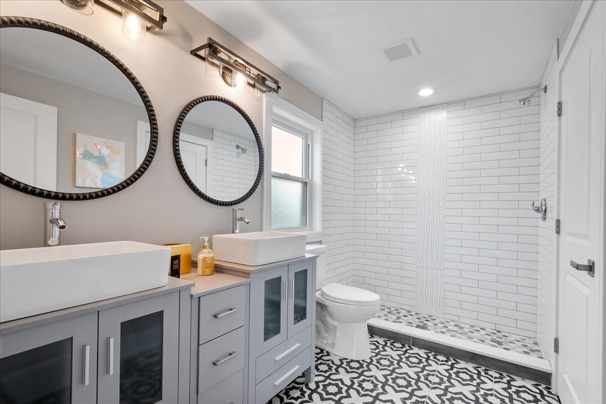 4855 West School Street Chicago, IL 60641 - Photo 19 of 29 a bathroom with a toilet a sink and a mirror