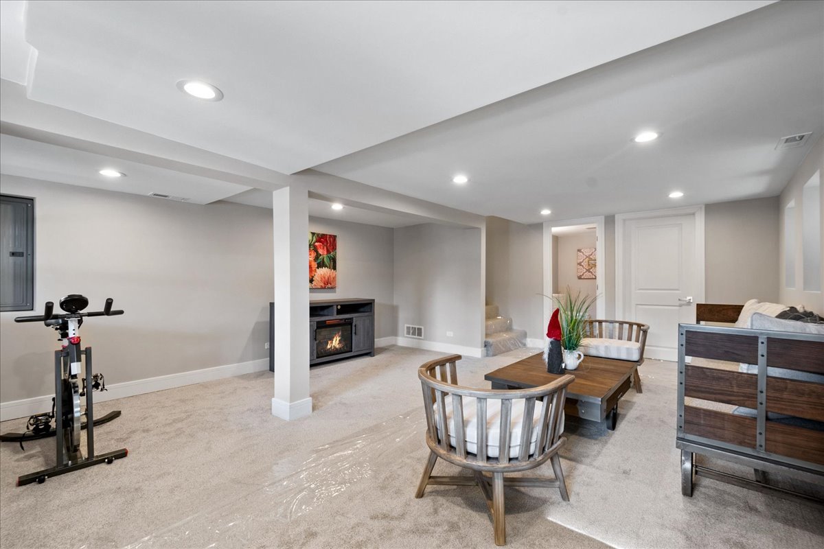 4855 West School Street Chicago, IL 60641 - Photo 22 of 29 a living room with furniture a flat screen tv and a table