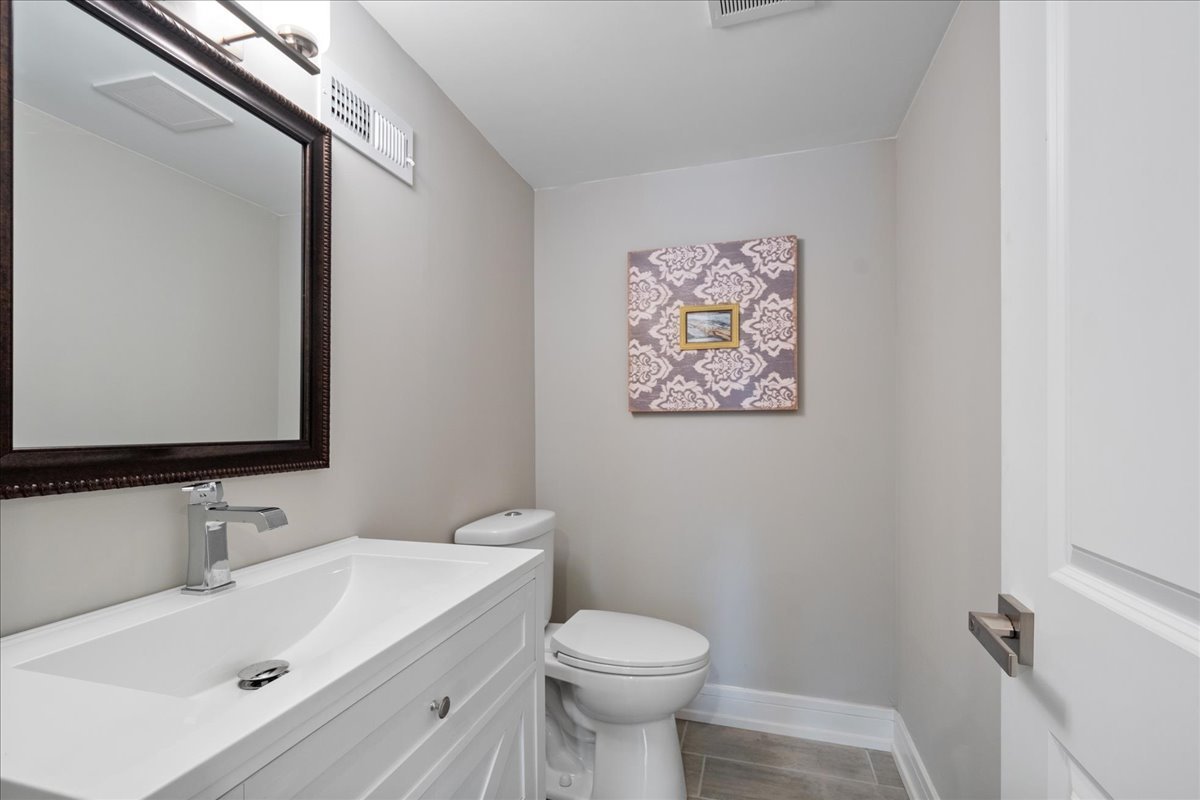 4855 West School Street Chicago, IL 60641 - Photo 25 of 29 a bathroom with a sink mirror and toilet