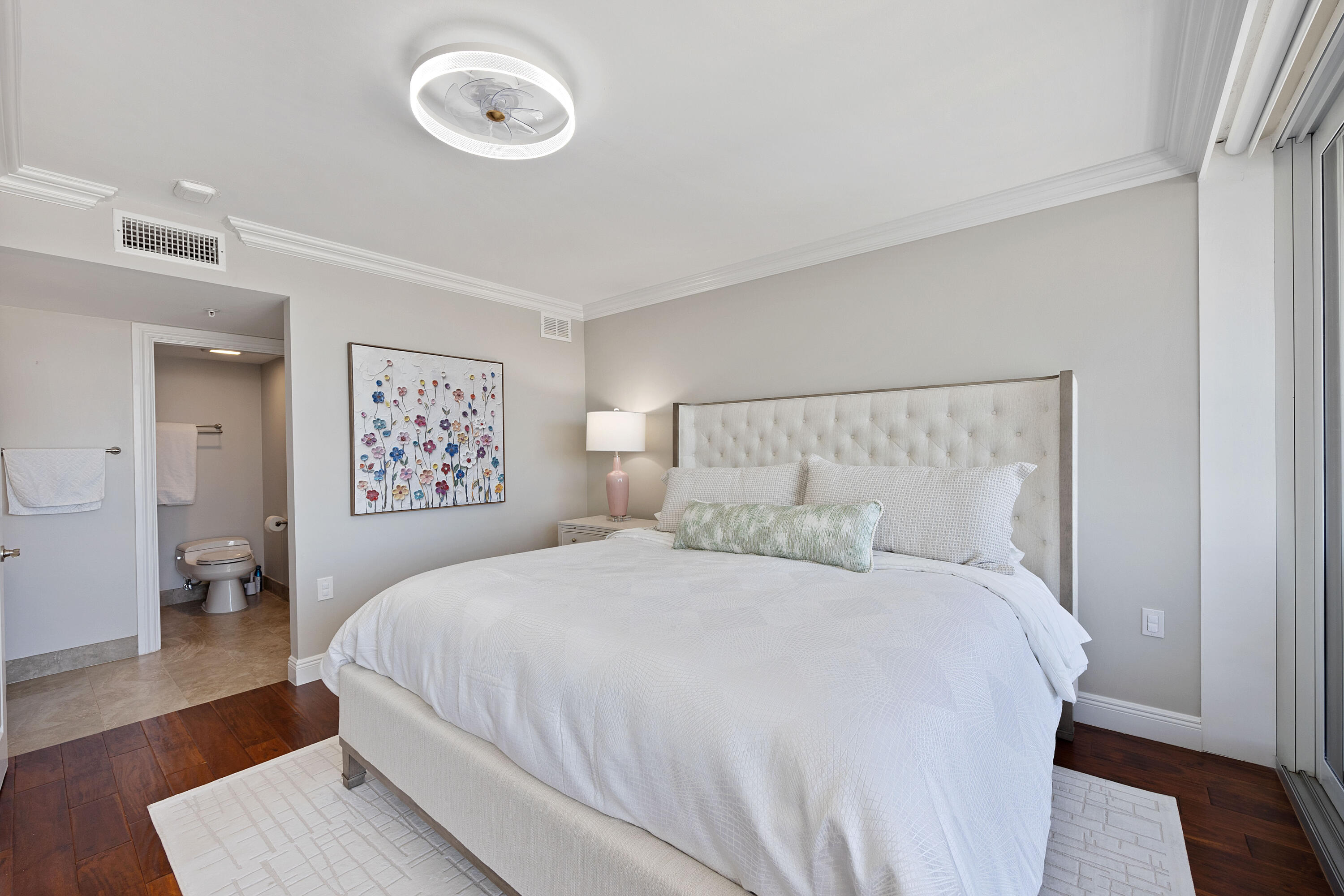 2401 Marina Isle Way, Unit 503 Jupiter, FL 33477 - Photo 15 of 30 a bedroom with a bed and wooden floor