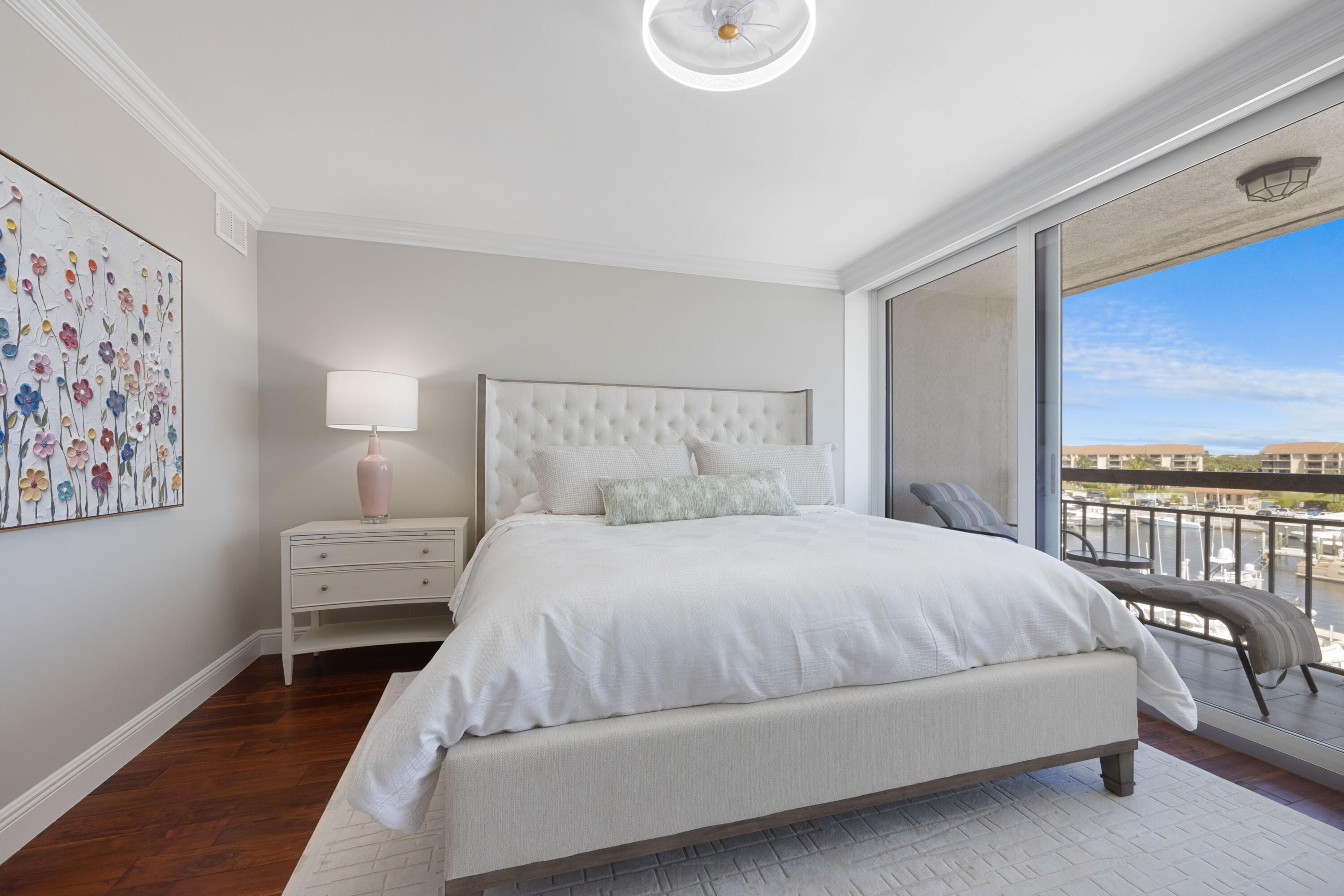 2401 Marina Isle Way, Unit 503 Jupiter, FL 33477 - Photo 16 of 30 a bedroom with a large bed and a couch