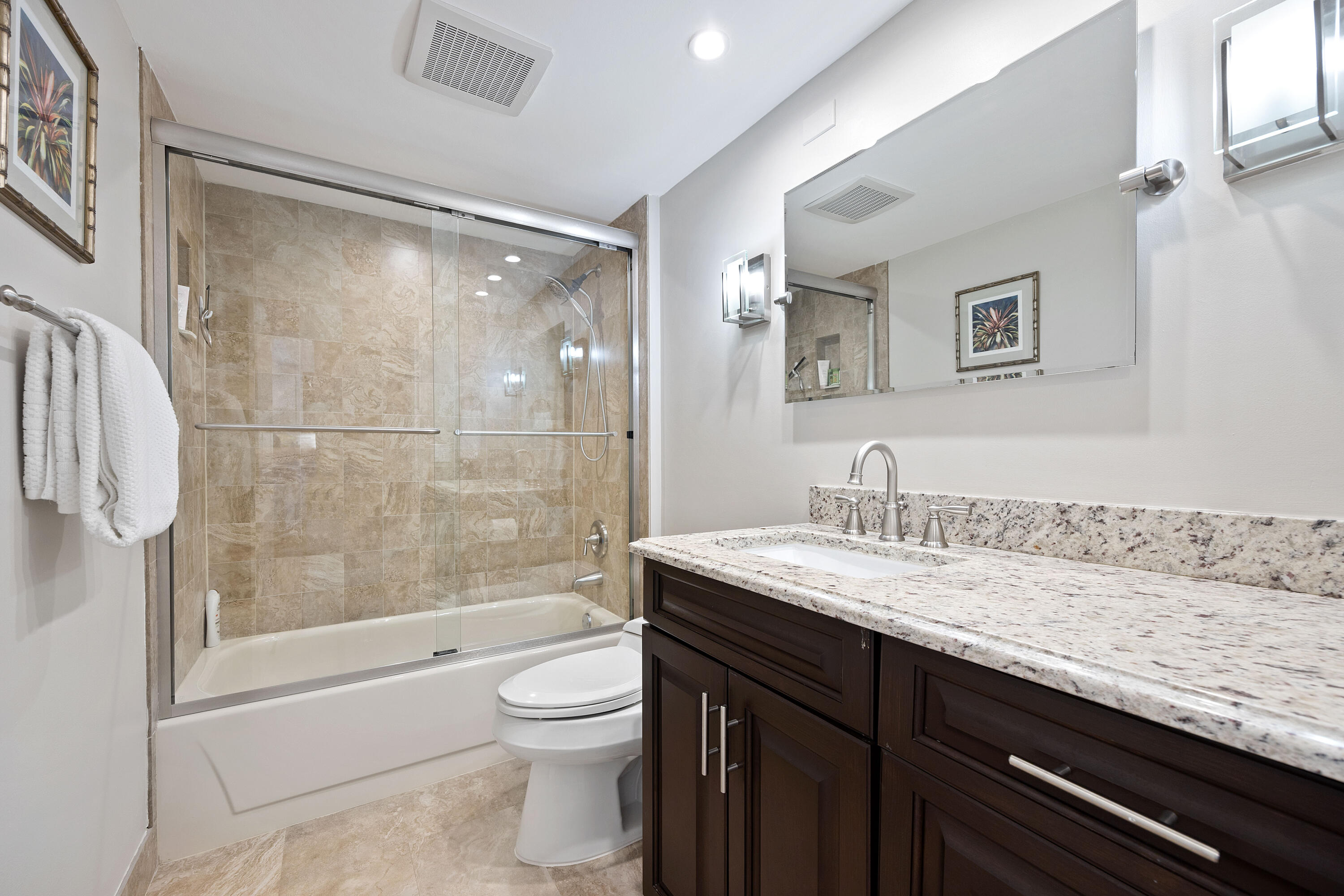 2401 Marina Isle Way, Unit 503 Jupiter, FL 33477 - Photo 23 of 30 a bathroom with a granite countertop sink toilet and shower