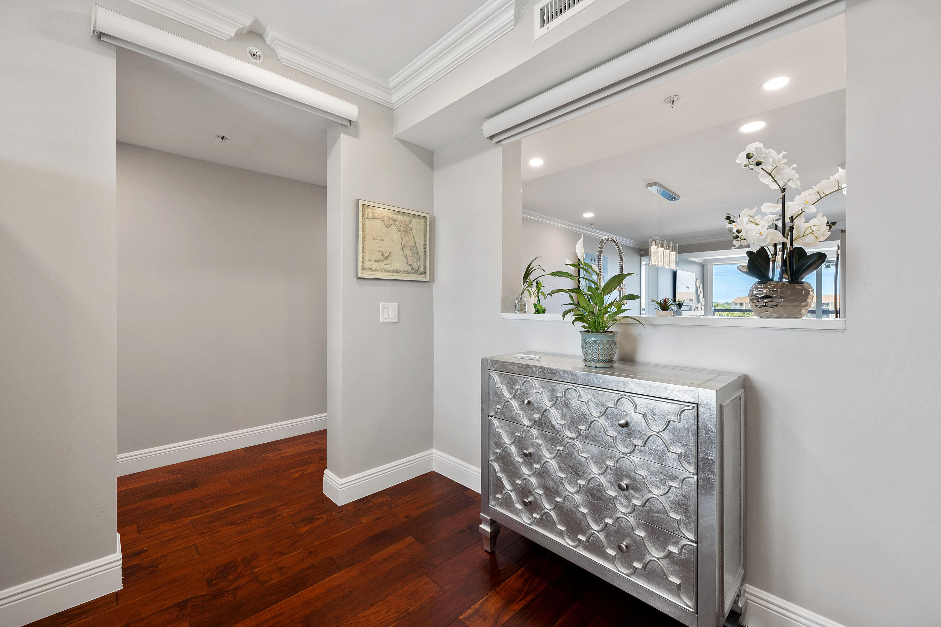 2401 Marina Isle Way, Unit 503 Jupiter, FL 33477 - Photo 25 of 30 a view of a living room with hardwood floor and a chandelier