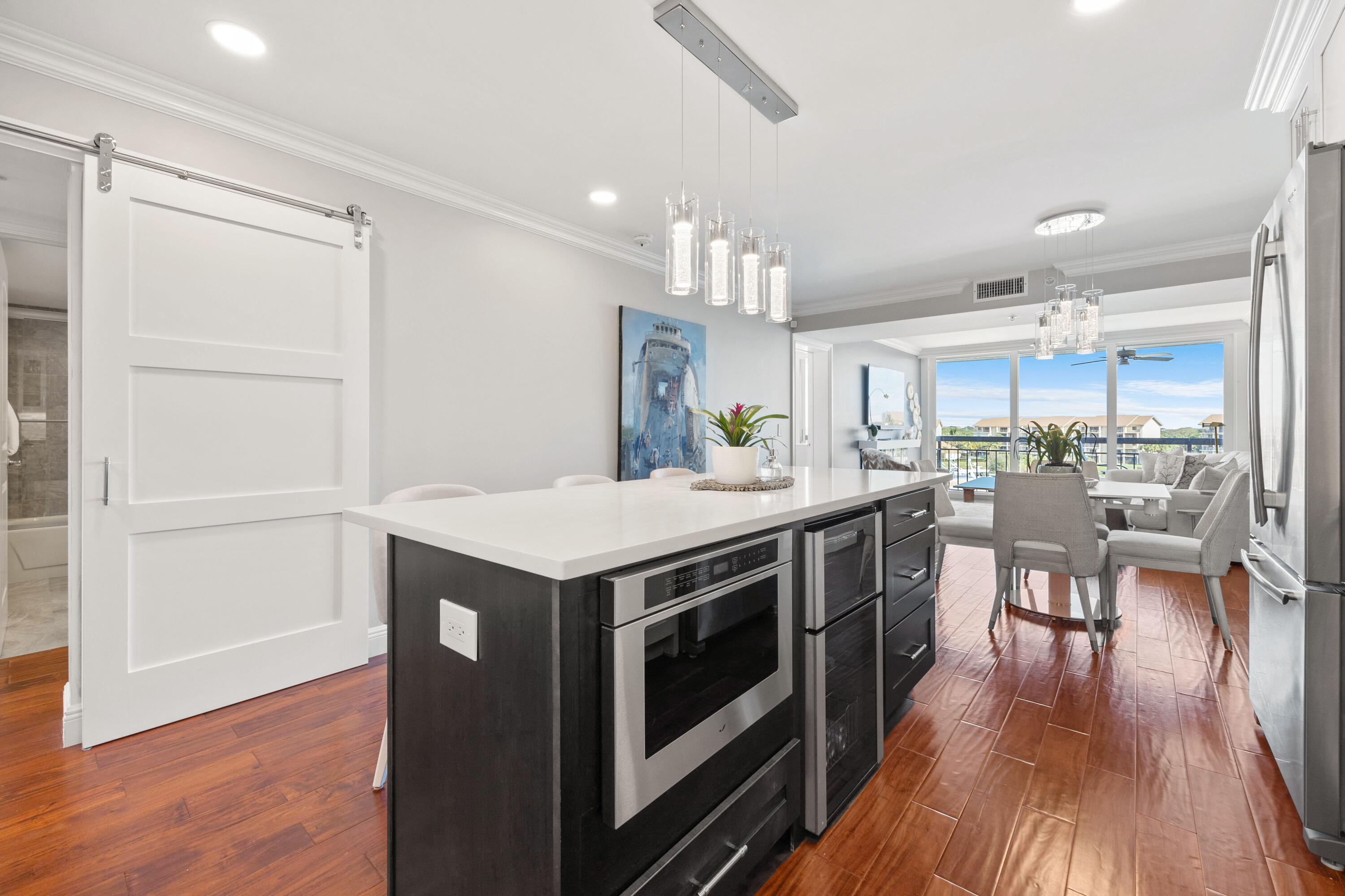 2401 Marina Isle Way, Unit 503 Jupiter, FL 33477 - Photo 6 of 30 a kitchen with stove and wooden floor