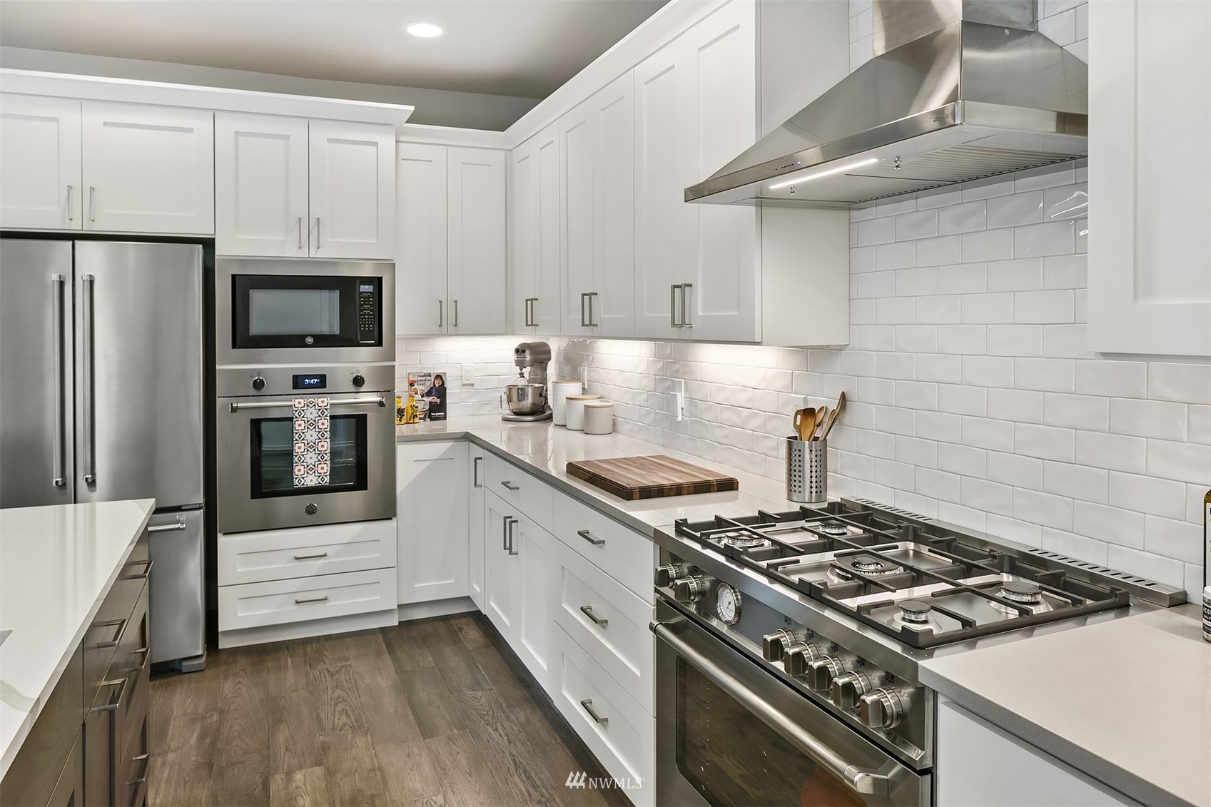236 234th Place Southeast Bothell, WA 98021 - Photo 18 of 39 a kitchen with white cabinets and stainless steel appliances