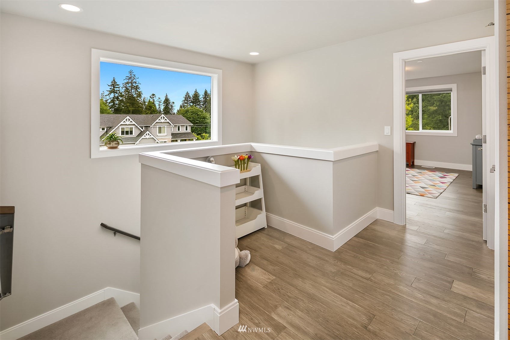 236 234th Place Southeast Bothell, WA 98021 - Photo 23 of 39 a view of a hallway with workspace and wooden floor