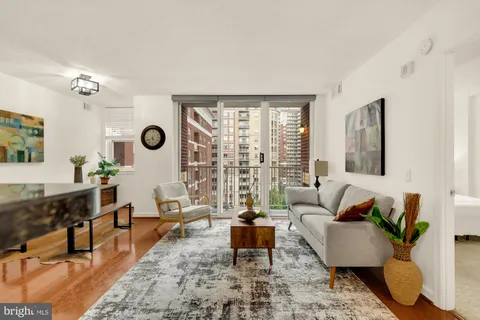 a living room with furniture potted plant and a table