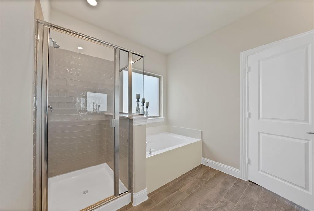 10401 Table Blf Street Aubrey, TX 76227 - Photo 13 of 25 a bathroom with a bathtub and a shower