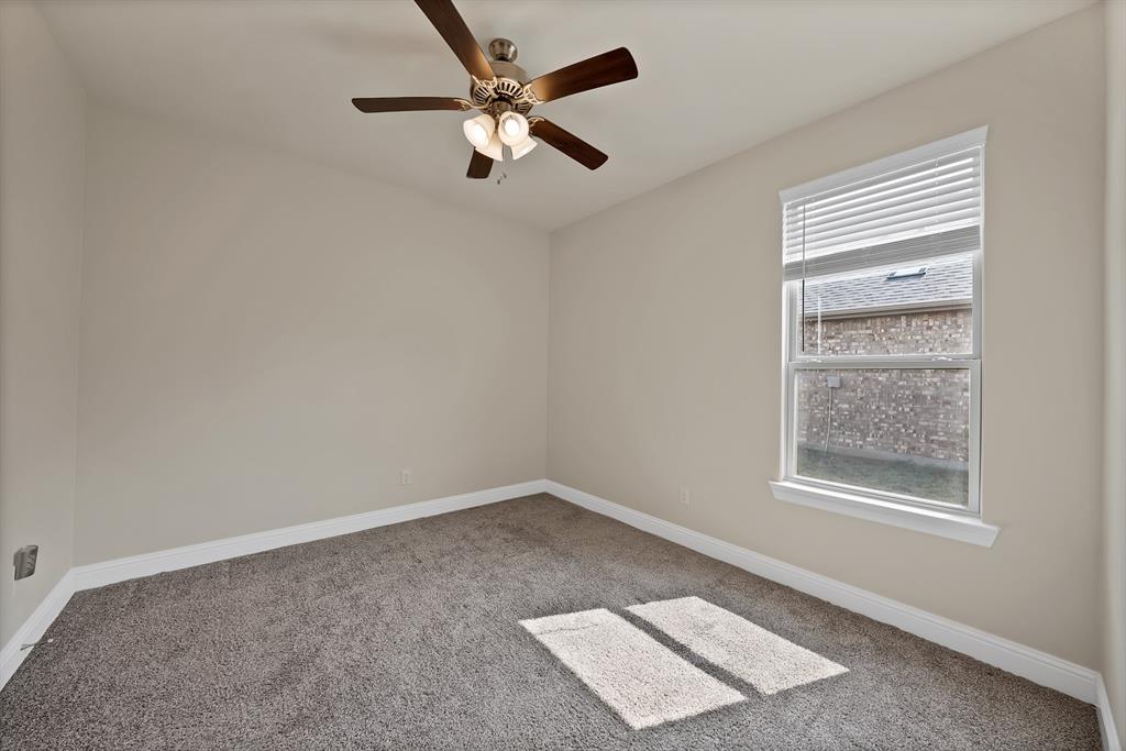 10401 Table Blf Street Aubrey, TX 76227 - Photo 15 of 25 an empty room with a window and a fan