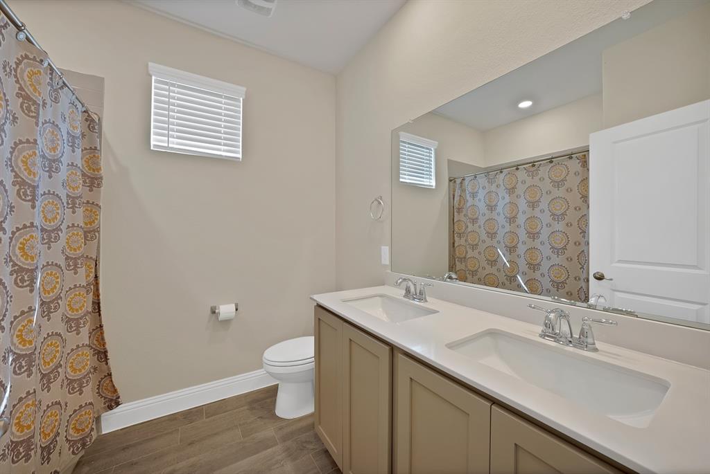 10401 Table Blf Street Aubrey, TX 76227 - Photo 16 of 25 a bathroom with a sink a toilet and shower