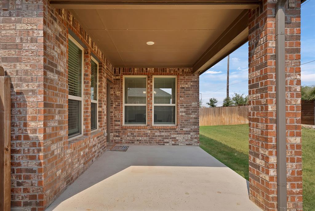 10401 Table Blf Street Aubrey, TX 76227 - Photo 20 of 25 a view of a porch with a floor to ceiling window next to a yard