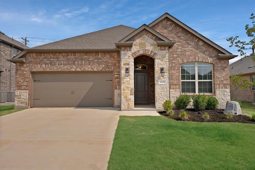10401 Table Blf Street Aubrey, TX 76227 - Photo 21 of 25 a front view of a house with a garden and plants