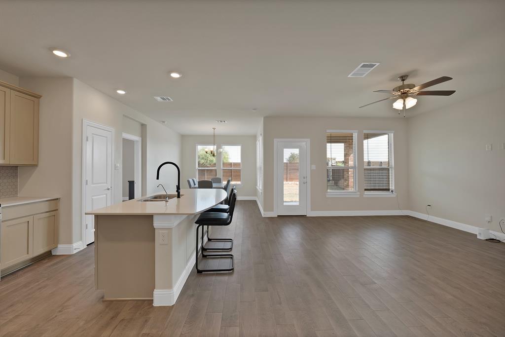 10401 Table Blf Street Aubrey, TX 76227 - Photo 4 of 25 a view of a kitchen with furniture and a ceiling fan