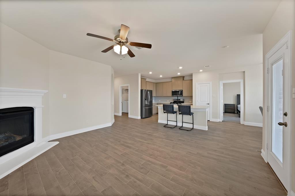 10401 Table Blf Street Aubrey, TX 76227 - Photo 5 of 25 a view of an empty room with kitchen and fireplace