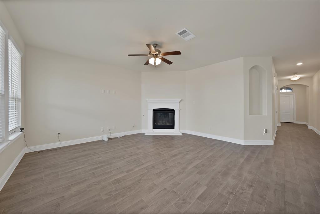 10401 Table Blf Street Aubrey, TX 76227 - Photo 7 of 25 an empty room with fan and windows
