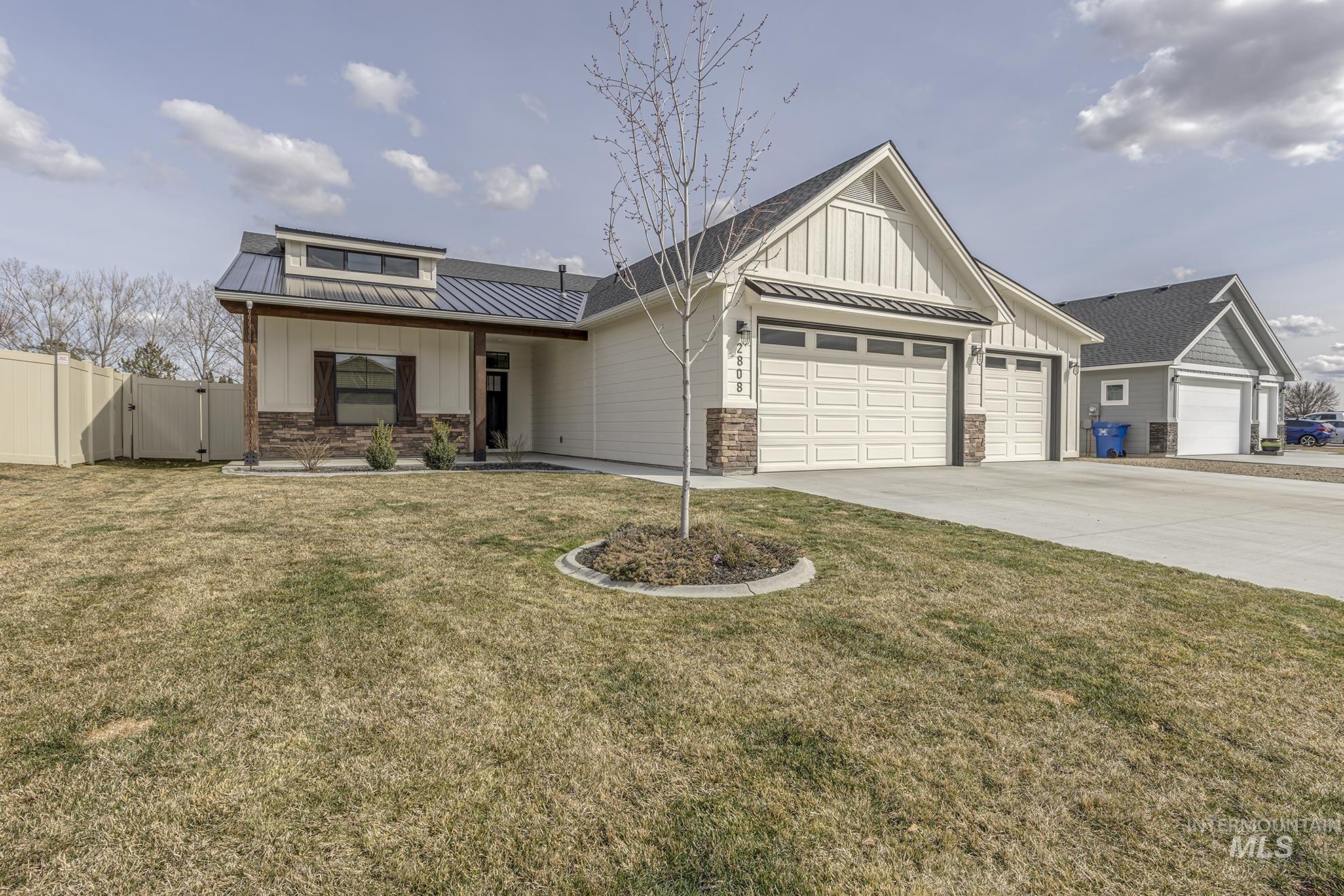 2808 Tamarack Street Fruitland, ID 83619 - Photo 2 of 36 View of front of home featuring a gate, a garage, board and batten siding, and a standing seam roof