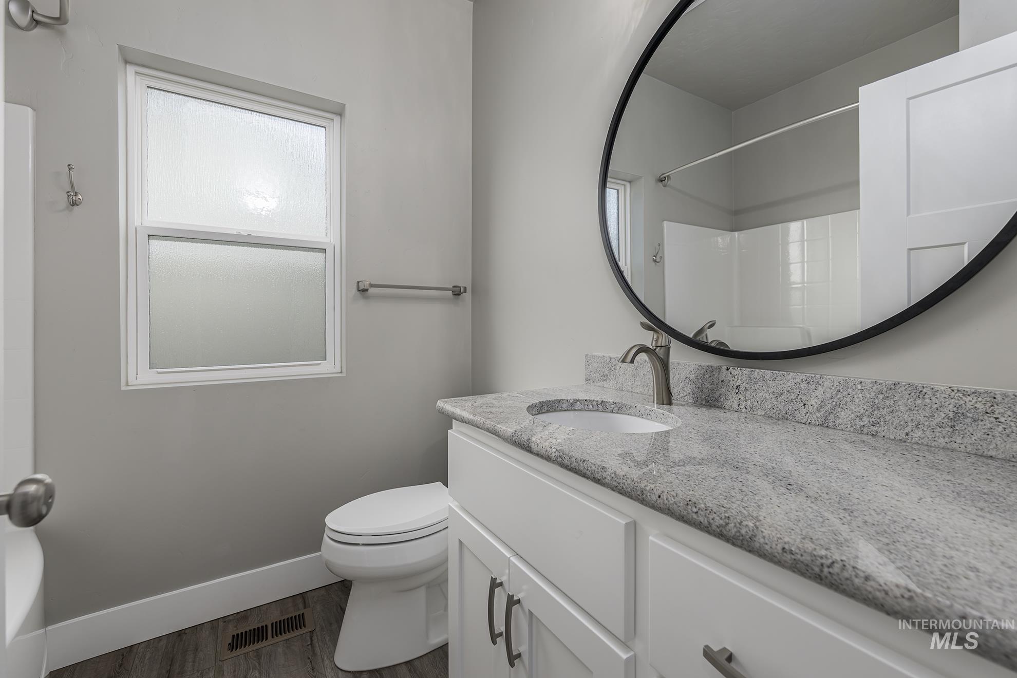 2808 Tamarack Street Fruitland, ID 83619 - Photo 25 of 36 Full bath with vanity, a shower, wood finished floors, and a bath