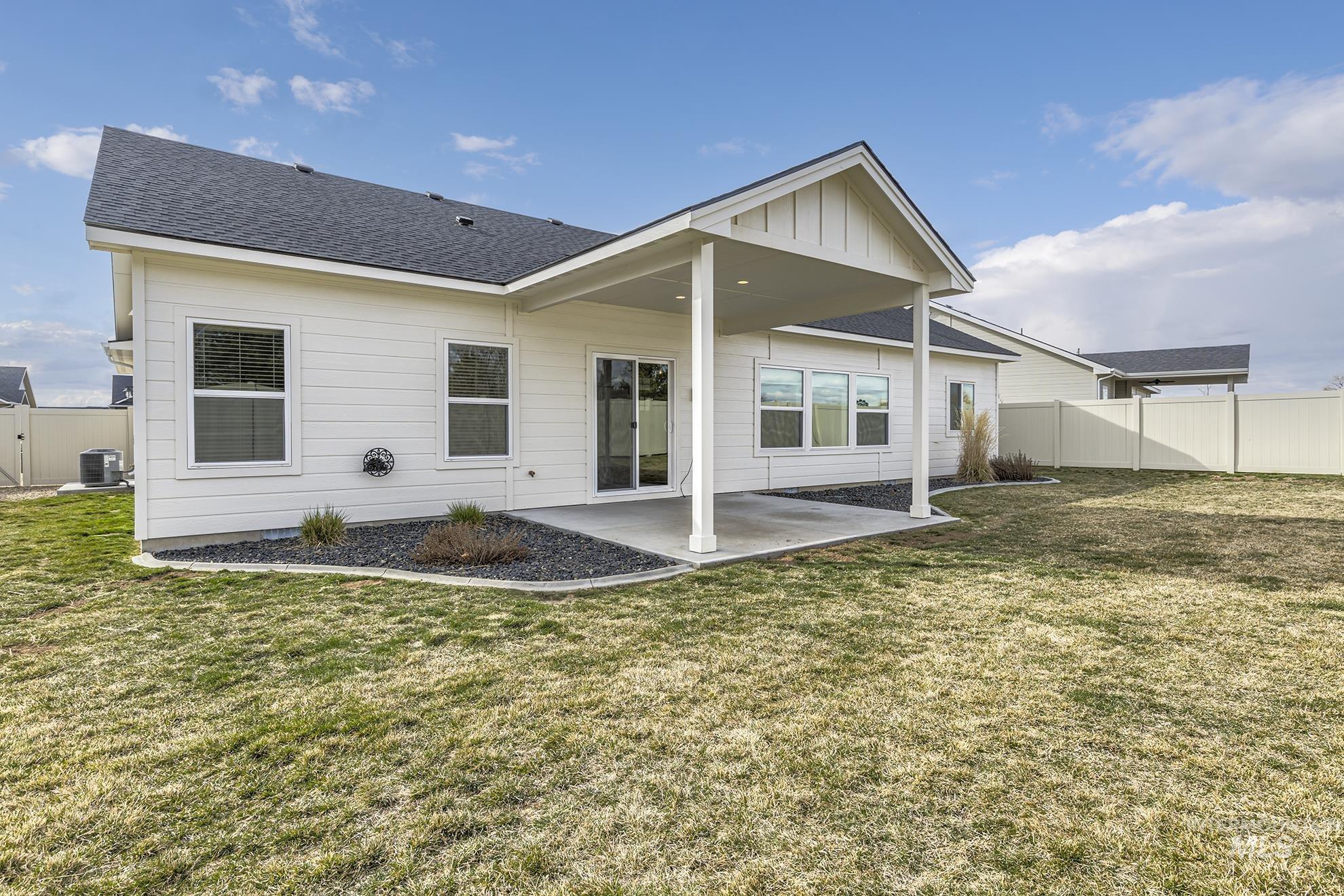 2808 Tamarack Street Fruitland, ID 83619 - Photo 31 of 36 Back of house with a fenced backyard, a patio area, roof with shingles, and a gate