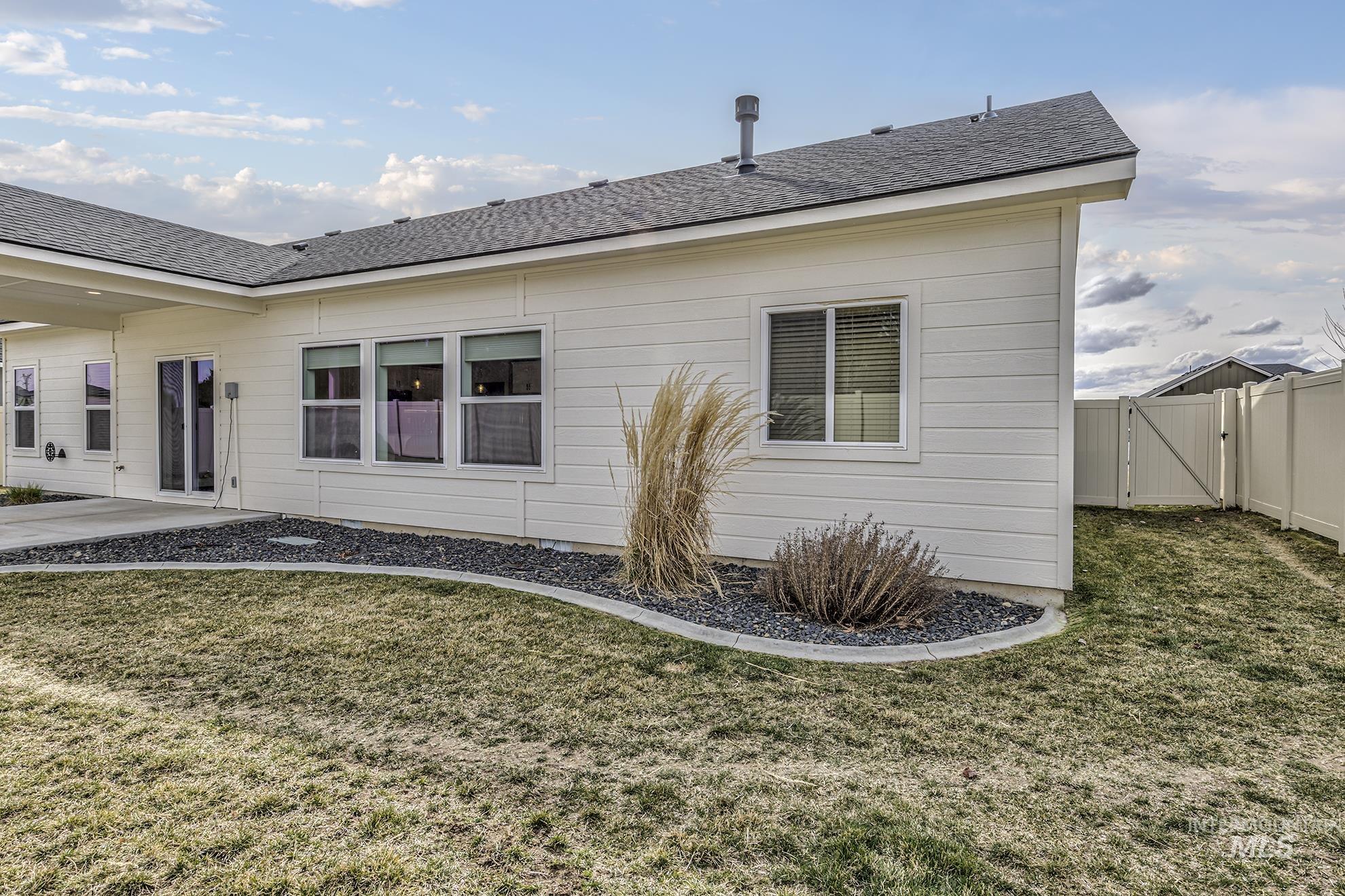 2808 Tamarack Street Fruitland, ID 83619 - Photo 33 of 36 Rear view of house featuring a gate, roof with shingles, and a patio
