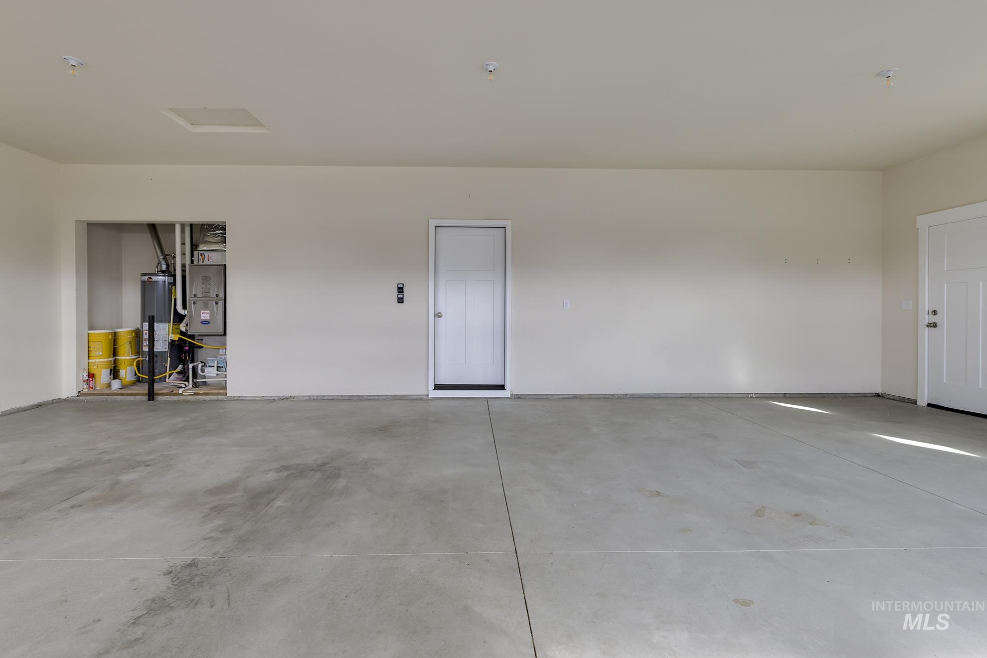 2808 Tamarack Street Fruitland, ID 83619 - Photo 36 of 36 Garage featuring water heater and heating unit