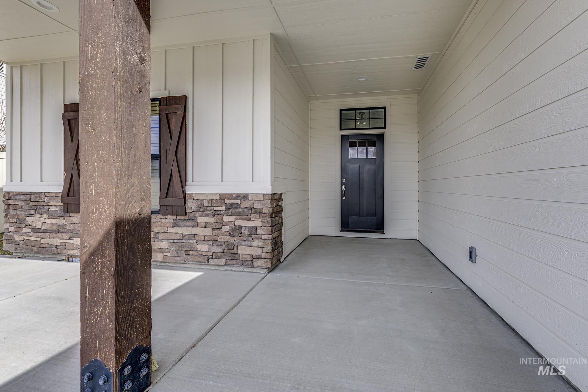 2808 Tamarack Street Fruitland, ID 83619 - Photo 4 of 36 Property entrance with a porch, board and batten siding, and stone siding