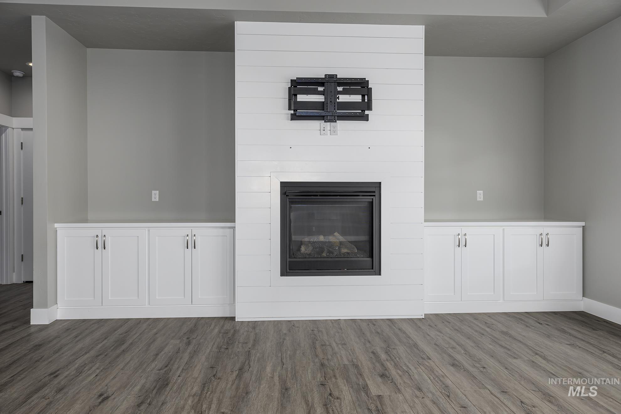 2808 Tamarack Street Fruitland, ID 83619 - Photo 8 of 36 Unfurnished living room with a fireplace and dark wood finished floors