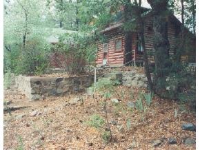 a backyard of a house with lots of green space and chair