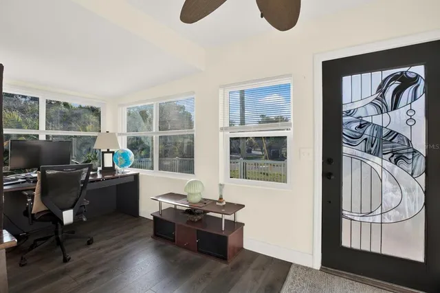a living room with furniture and a floor to ceiling window