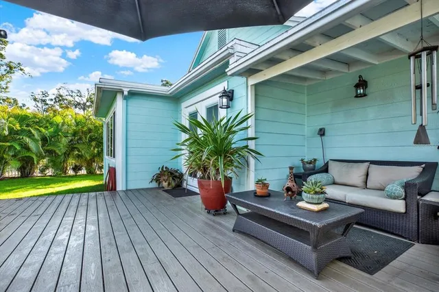 a view of a couches in the patio with potted plants