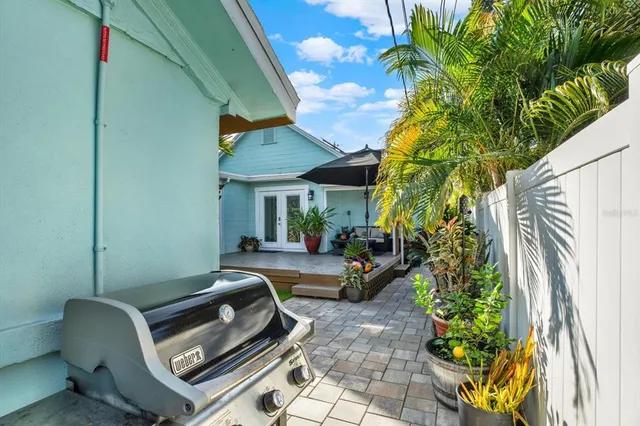 a view of a patio with chairs and potted plants