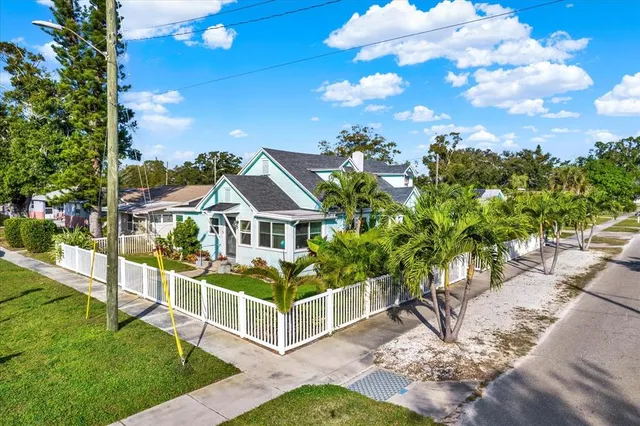 a view of a house with a big yard and large trees