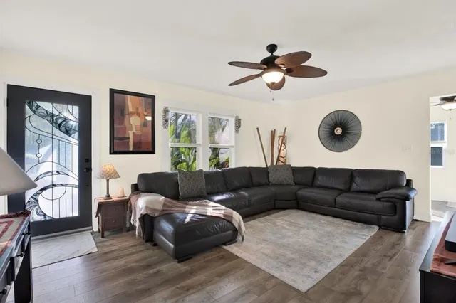 a living room with furniture and a wooden floor