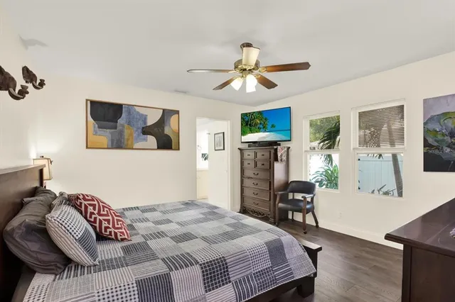 a bedroom with a bed furniture and a flat tv screen