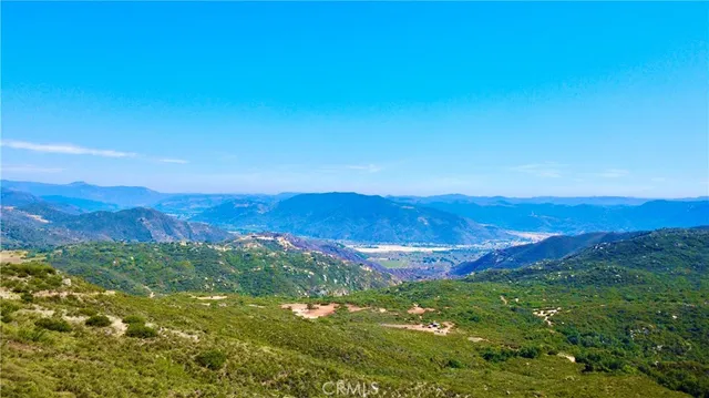 a view of a large mountain with mountains in the background