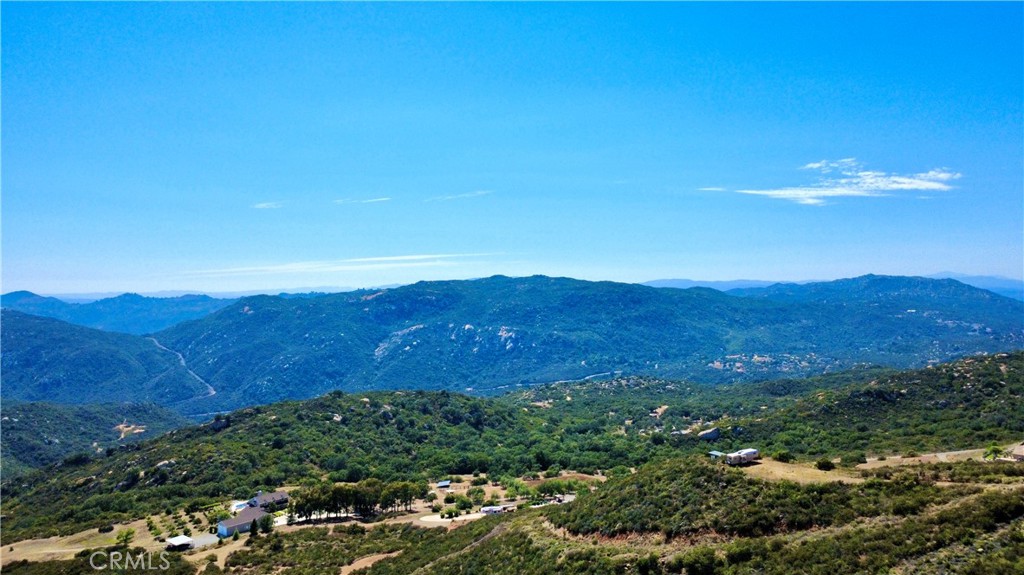 0 Sunset Peak Pala, CA 92059 - Photo 15 of 18 a view of a lush green hillside and a building