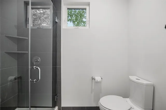 a white toilet sitting next to a bathroom sink