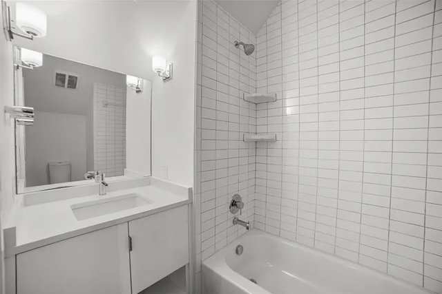 a bathroom with a sink a mirror and a bathtub