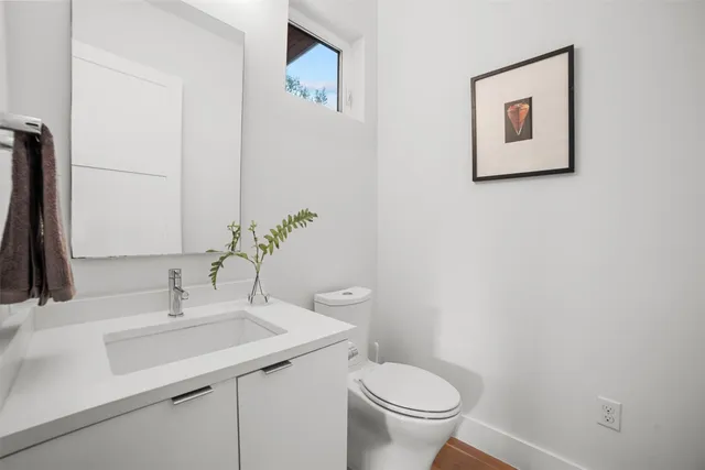 a bathroom with a toilet sink and mirror