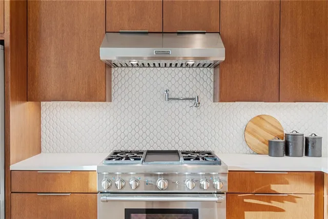 a stove top oven sitting inside of a kitchen