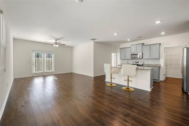 a view of kitchen with microwave and wooden floor
