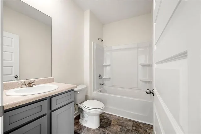 a bathroom with a sink a toilet and a bathtub