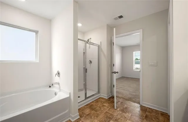 a bathroom with a tub shower and sink