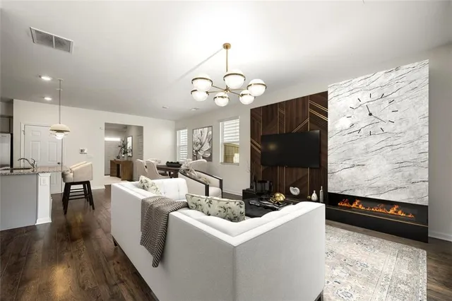 a living room with furniture and a chandelier