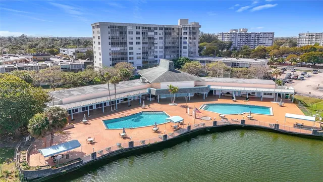 an aerial view of a house with a swimming pool outdoor seating and yard