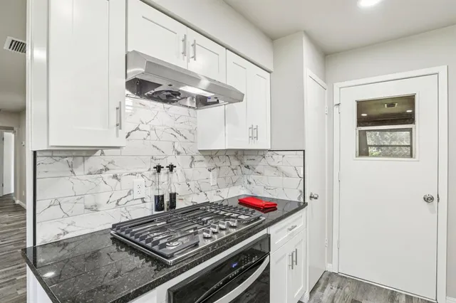 a kitchen with a stove and cabinets