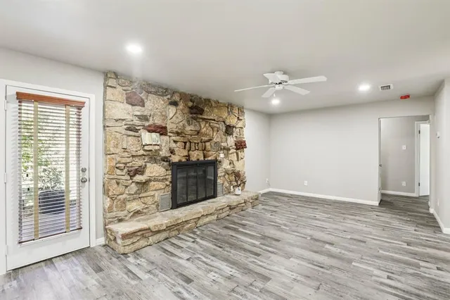 a view of an empty room with a fireplace