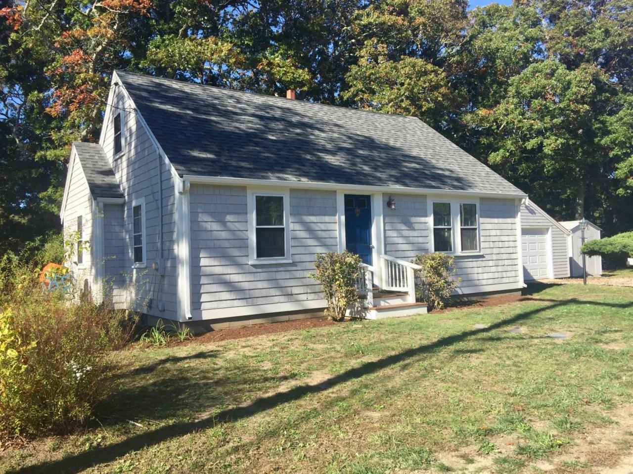 133 Old Town Road Hyannis, MA 02601 - Photo 1 of 29 a backyard of a house with yard and outdoor seating