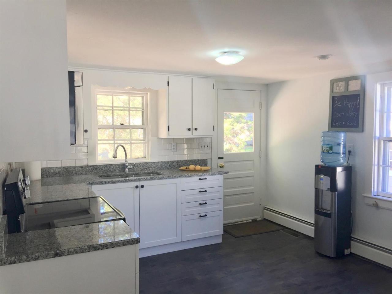 133 Old Town Road Hyannis, MA 02601 - Photo 3 of 29 a kitchen with granite countertop white cabinets and white appliances